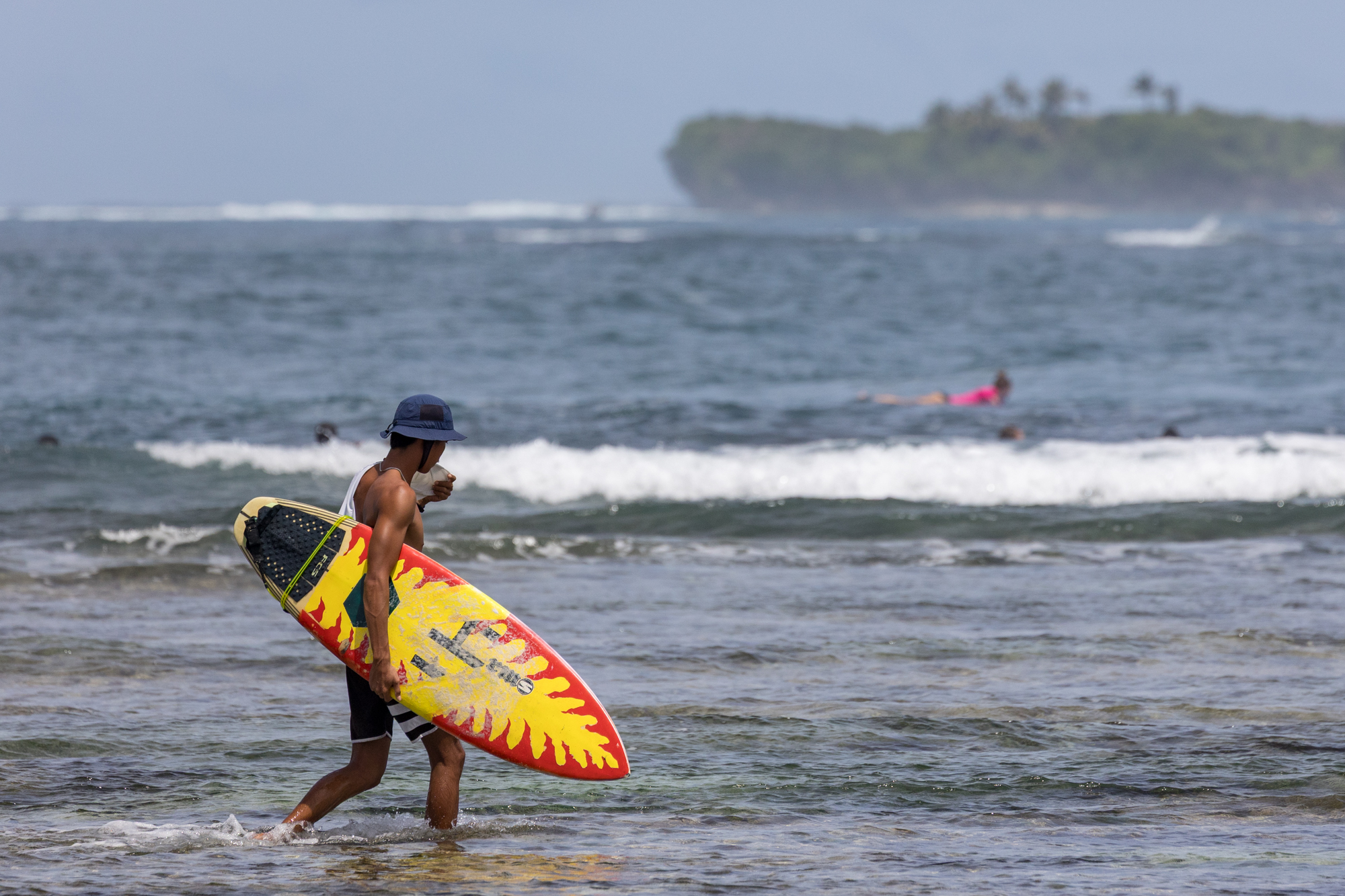 Local and foreign tourists catch waves at Cloud 9, a popular surf spot on Siaragao Island. Siargao Island is known as the surf capital of the Philippines. March 1, 2025. Kathleen Lei Limayo/Thomson Reuters Foundation