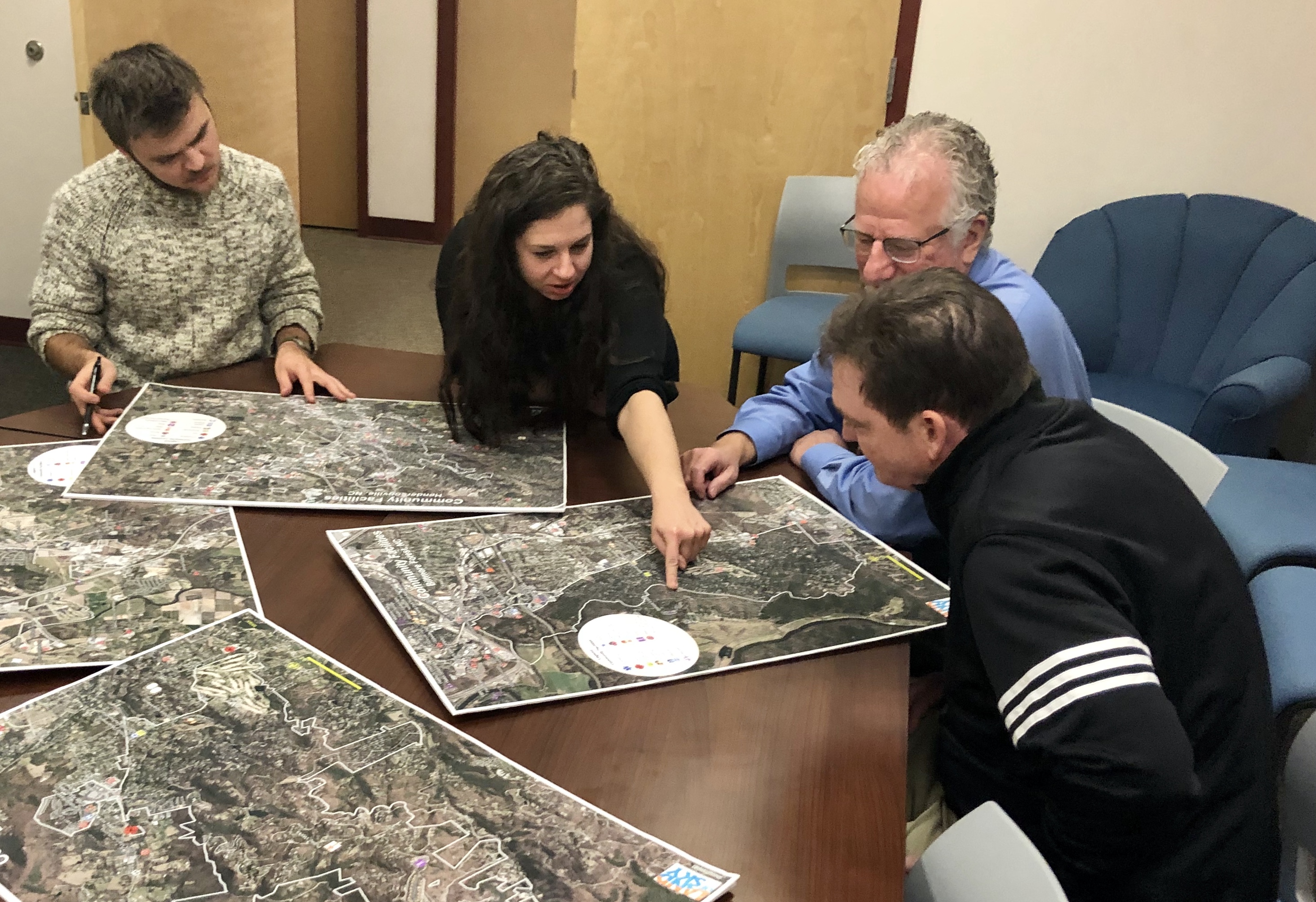 Officials and community members look at maps to identify places in western North Carolina unable connect to broadband services in 2018. Land of Sky Regional Council/Handout via Thomson Reuters Foundation