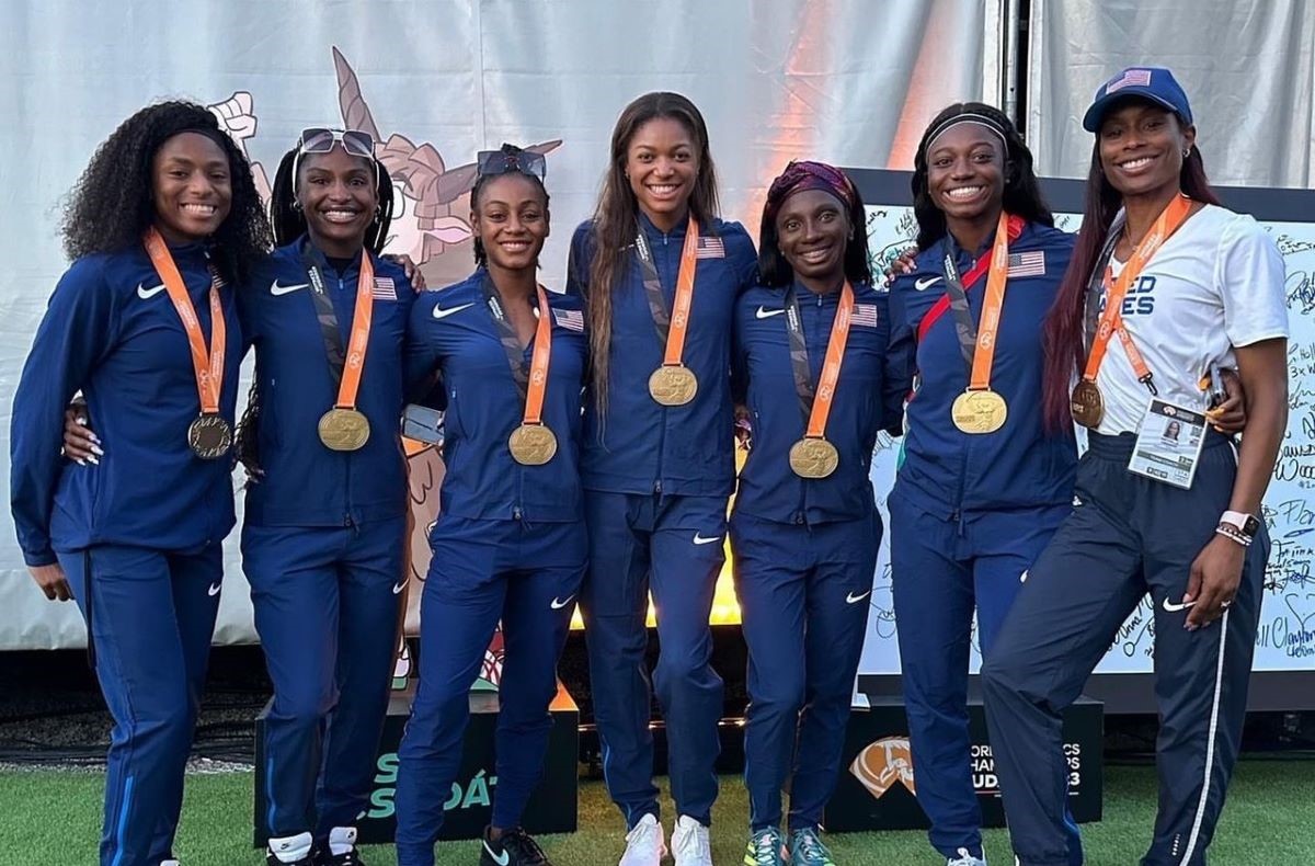 U.S. relay coach Mechelle Lewis Freeman (right) stands with members of the U.S. women's relay team at the World Athletics Championships in Budapest, August 2023.  Thomson Reuters Foundation/Handout via Female Coaching Network