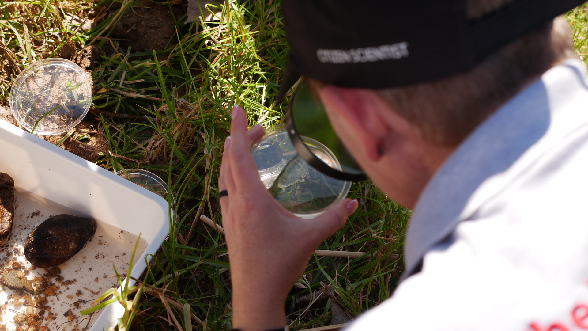 Linda Downsborough, head of environmental science at IIE MSA, examines a water sample from the Wilgespruit river in Johannesburg, South Africa, May 29, 2025. Thomson Reuters Foundation/Kim Harrisberg