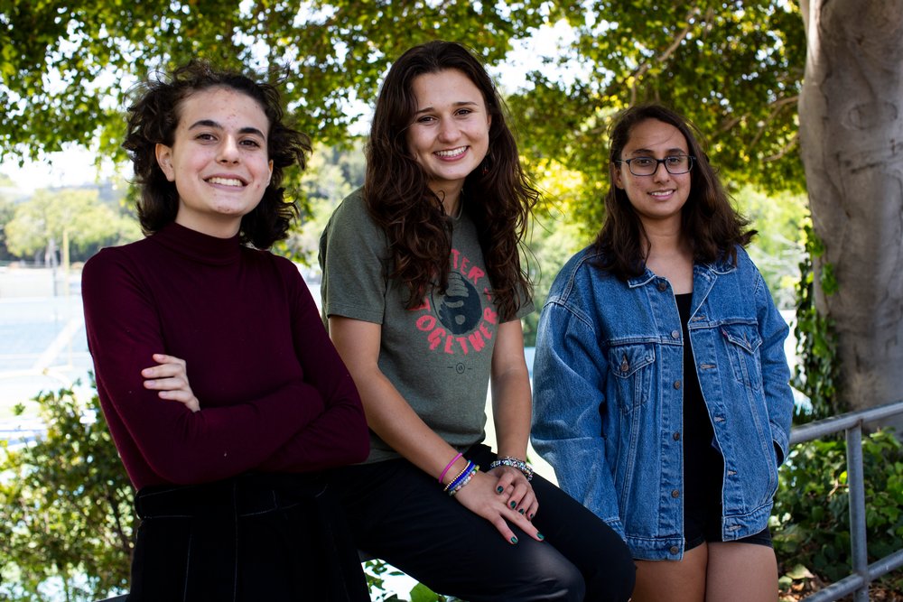 Young climate change activists Madison Liberman (L), Isabel Gill (C) and Nathalia Wyss (R) pose in front of Palisades High School in Los Angeles, California, June 3, 2021