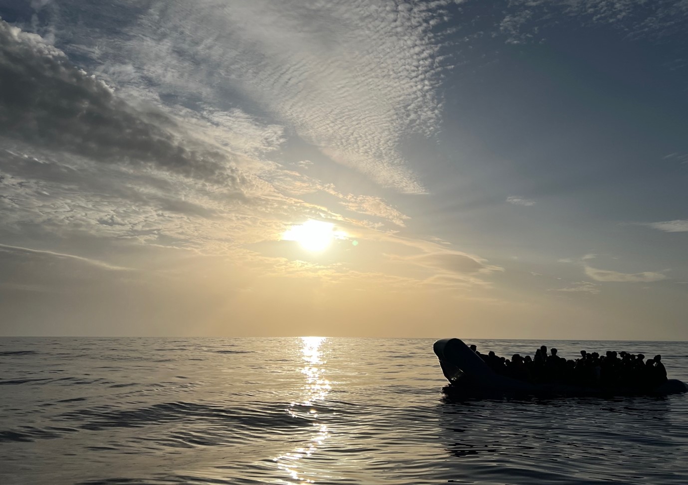 An overcrowded rubber boat with 70 people onboard is drifting out to sea, 31 nautical miles from the Libyan coast, November 20, 2024. Seán Columb/Thomson Reuters Foundation