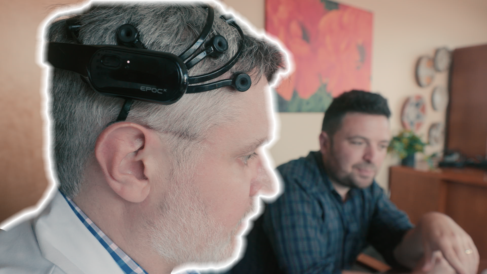 A still shows a man wearing an Emotiv Brain-Computer-Interface neurotech device. Thomson Reuters Foundation.